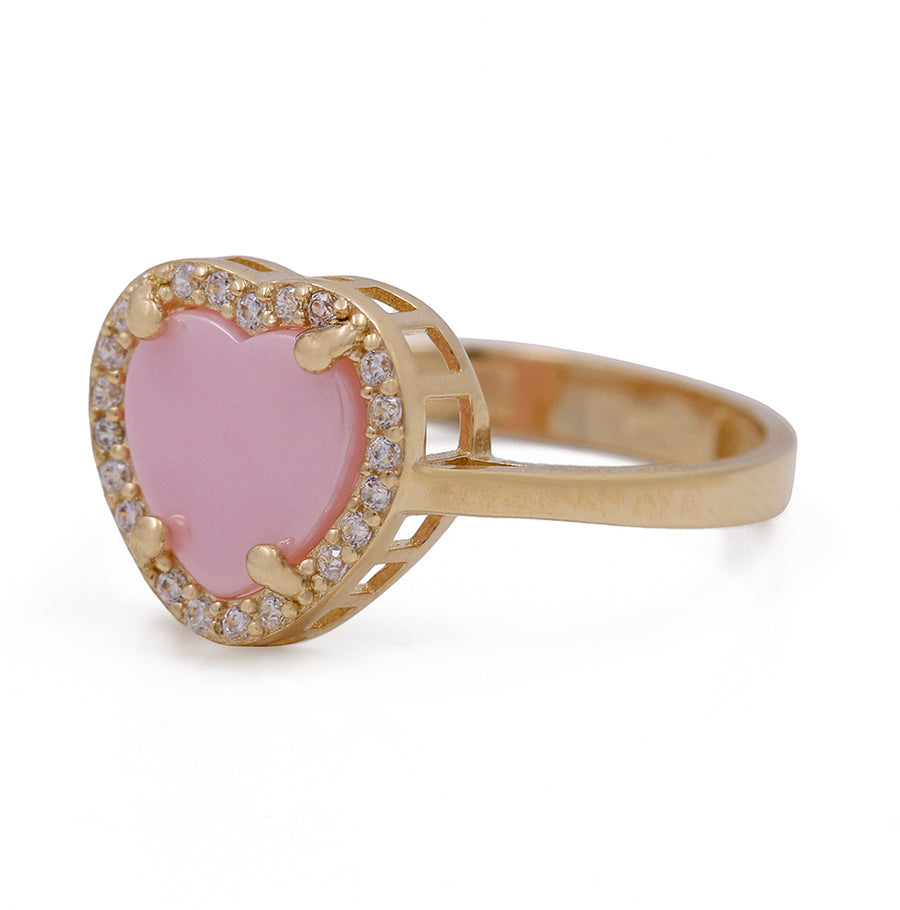 A 14K Yellow Gold Fashion Pink Stone Heart with Cubic Zirconias Ring adorned with sparkling diamonds, by Miral Jewelry.