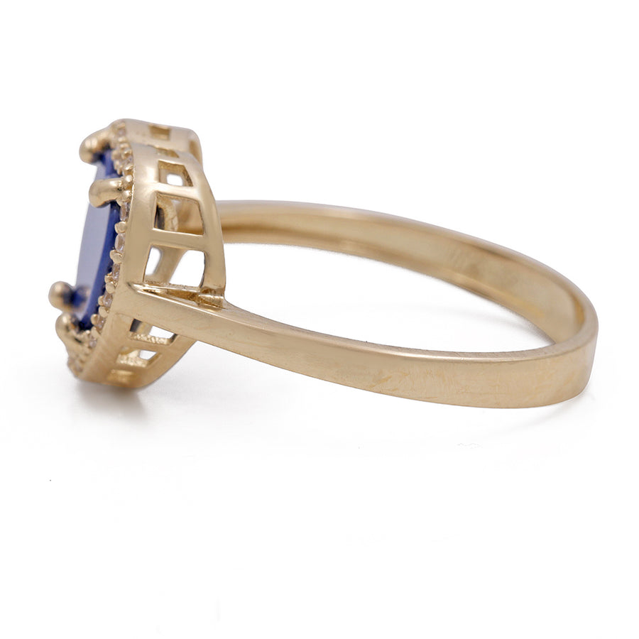A Miral Jewelry 14K Yellow Gold Fashion Ring with Blue Heart Center Stone and Cubic Zirconias, perfect for fashion-forward individuals seeking a unique twist on their jewelry collection.