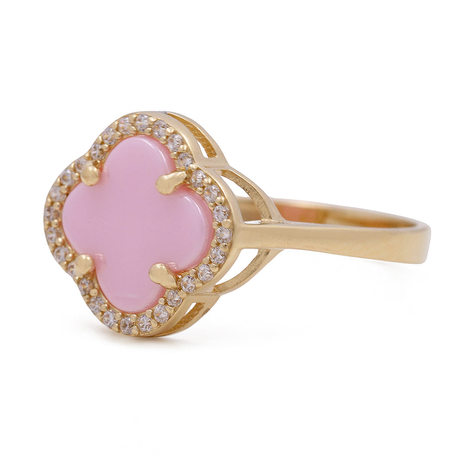 A Miral Jewelry fashion ring featuring a 14K yellow gold band, adorned with a pink color stone and accentuated with cubic zirconias.