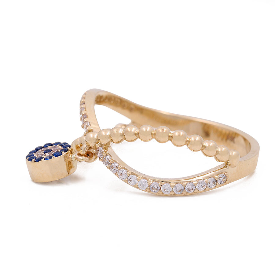 A 14K Yellow Gold with Blue Stone Bead and Cubic Zirconias ring from Miral Jewelry, with an evil eye.