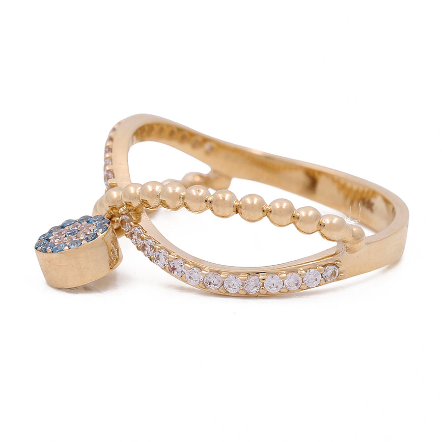 A Miral Jewelry yellow gold ring with blue diamonds and 14K Yellow Gold.