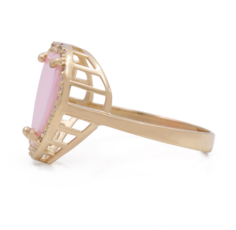 A dazzling Miral Jewelry 14K Yellow Gold Fashion Pink Stone Heart with Cubic Zirconias Ring adorned with sparkling diamonds, making it a timeless piece of fashion.