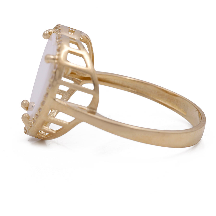 A Miral Jewelry 14K Yellow Gold Fashion Ring with Mother of Pearl Heart Center Stone and Cubic Zirconias.