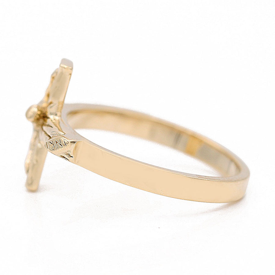 A Miral Jewelry 14K Yellow Gold Fashion Jesus on the Cross Ring adorned with sparkling diamonds, exuding both fashion and spiritual elegance.