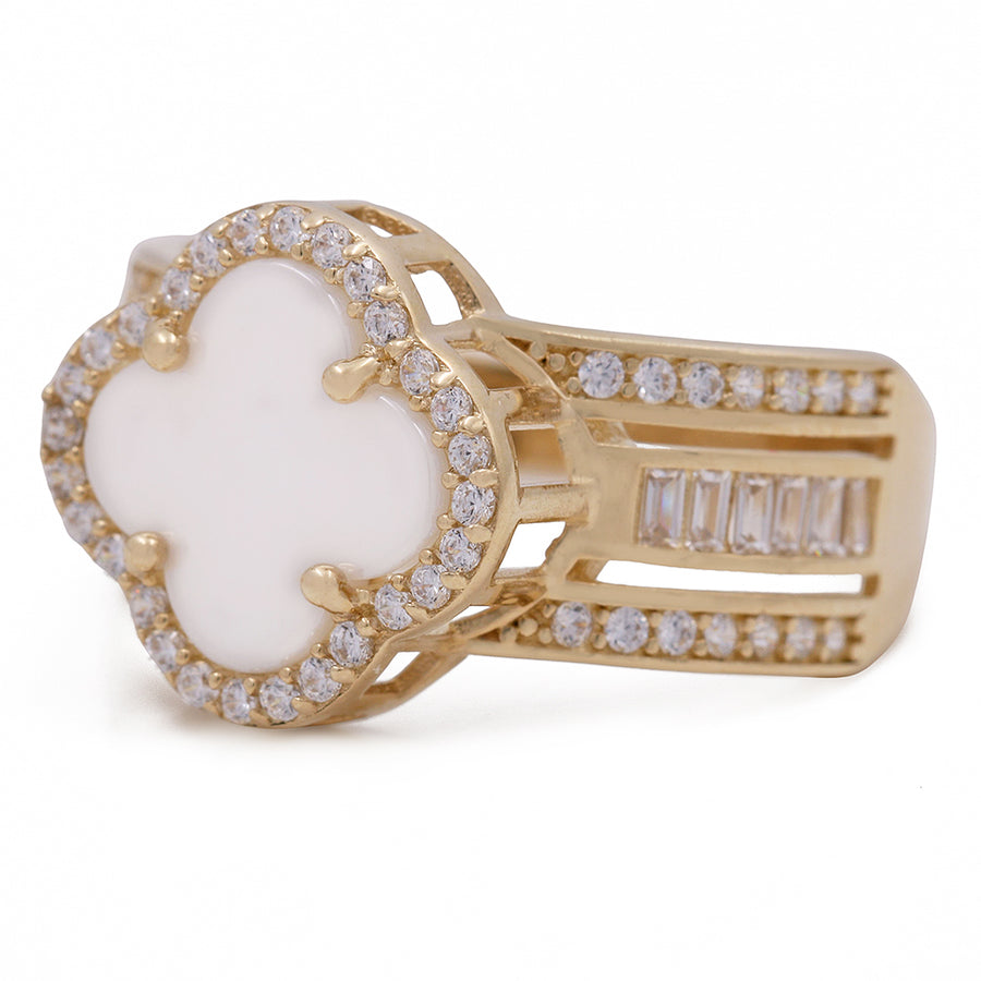 A white and gold clover ring with diamonds and Mother of Pearl.
Product: A 14K Yellow Gold Fashion Mother of Pearl Flower with Cubic Zirconias Ring by Miral Jewelry.