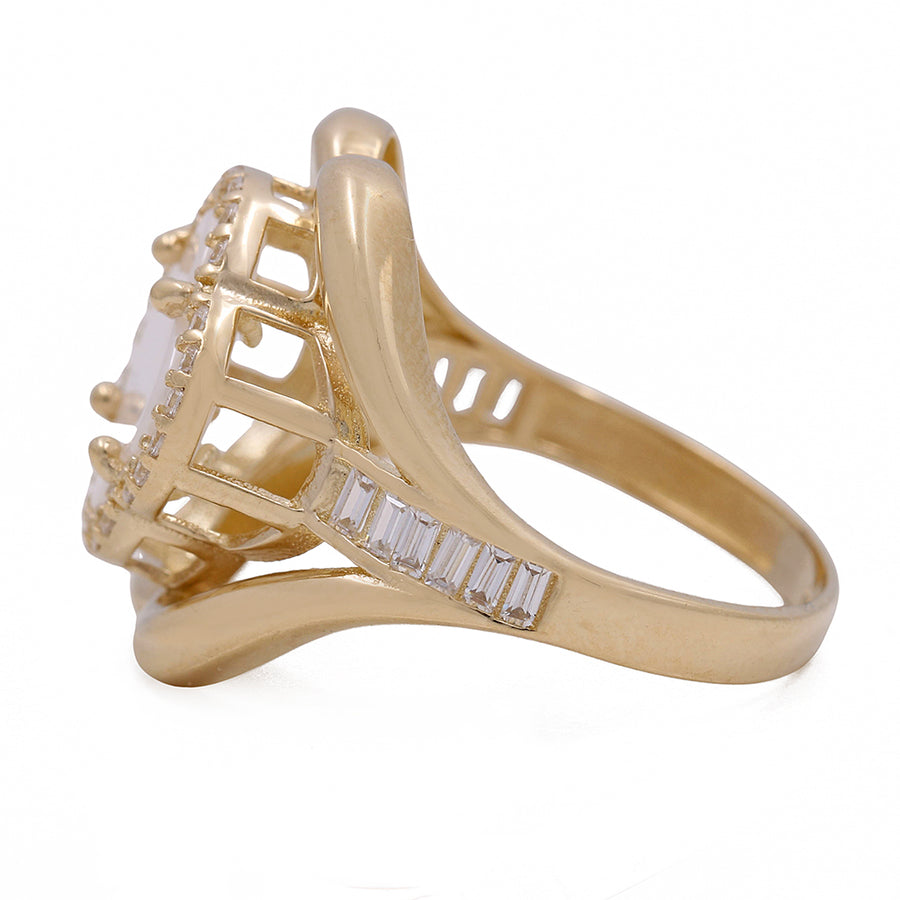 A Miral Jewelry yellow gold ring with a white stone and baguette diamonds, crafted in Miral Jewelry's 14K yellow gold.