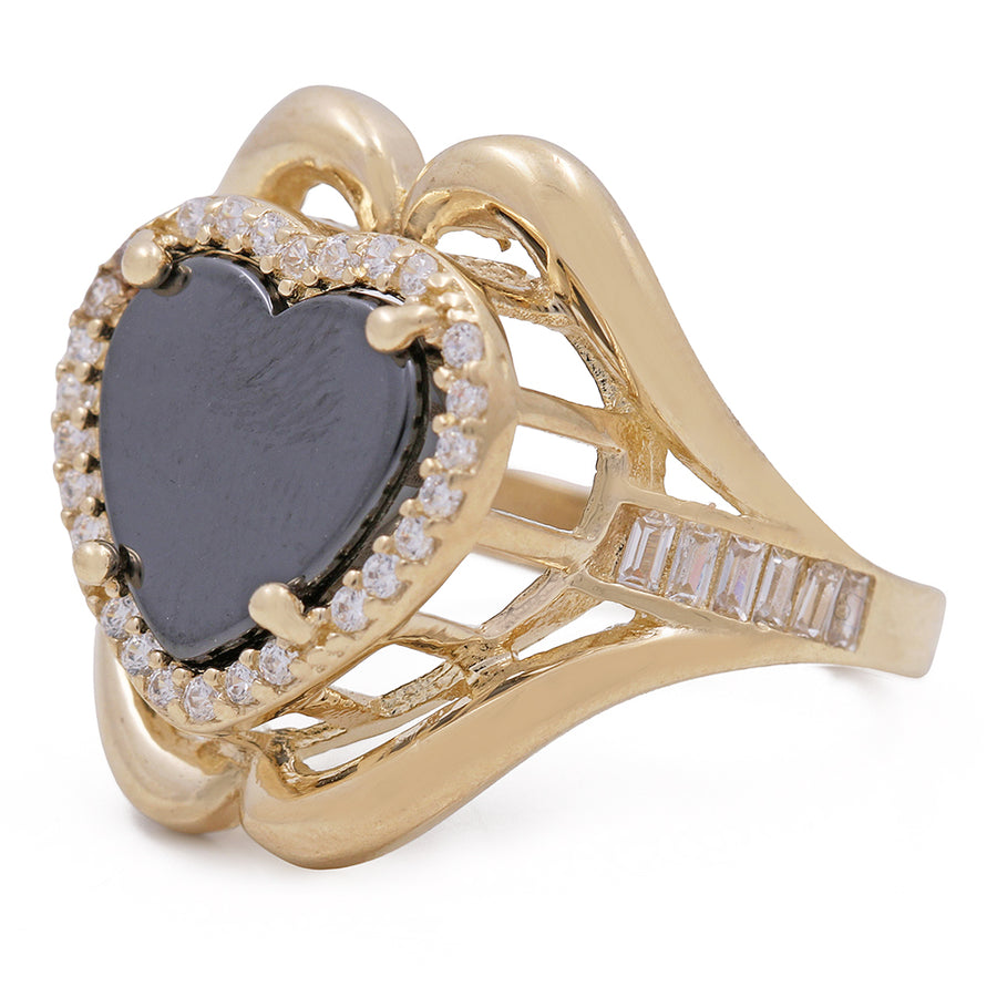 A heart shaped Miral Jewelry black onyx and diamond ring in yellow gold, with a 14K yellow gold fashion band and a Miral Jewelry onyx heart center stone.