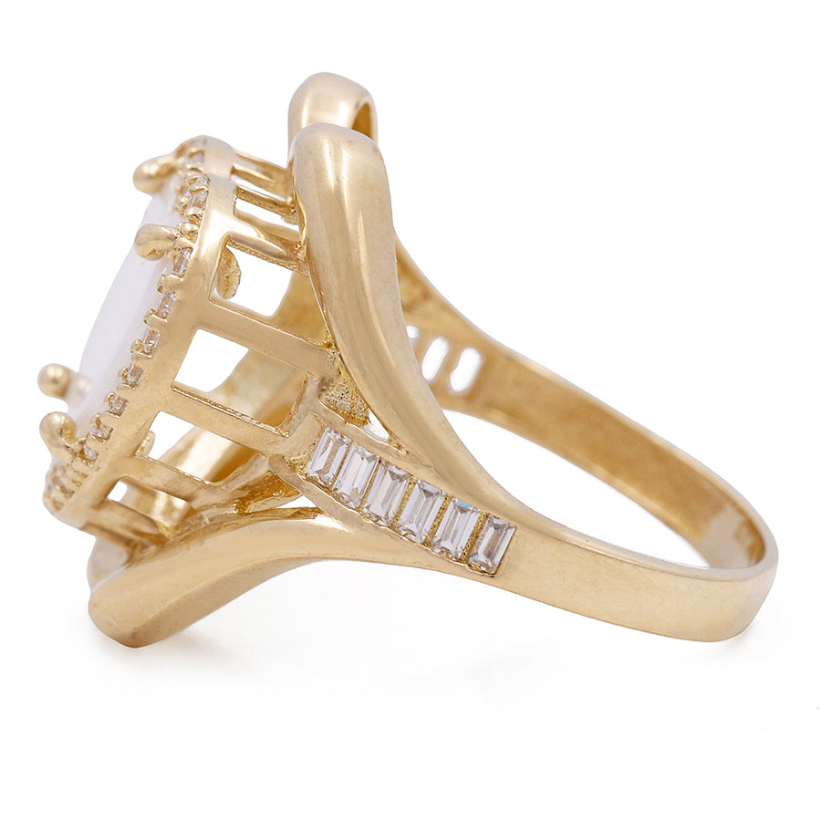 A Miral Jewelry 14K Yellow Gold Fashion Ring with Mother of Pearl Center Stone and Cubic Zirconias, with baguette diamonds.