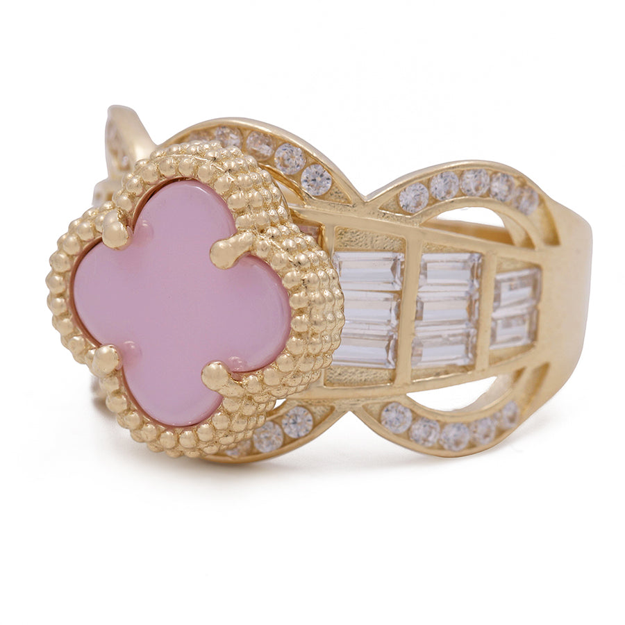 A Miral Jewelry fashion ring featuring a pink color stone set in 14K yellow gold, accentuated by cubic zirconias.