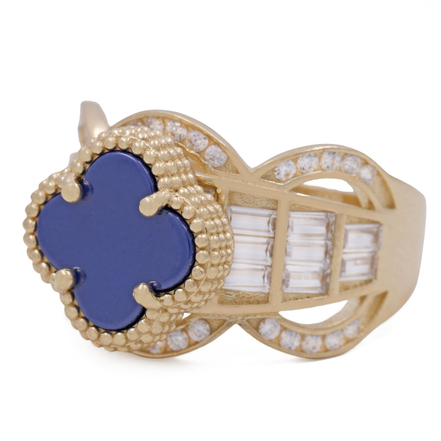 A Miral Jewelry fashion ring featuring a 14K Yellow Gold band adorned with a brilliant blue color stone and complemented by sparkling cubic zirconias.