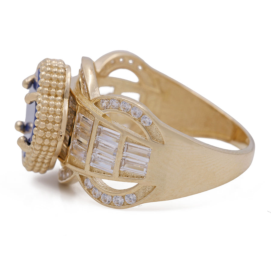 A Miral Jewelry fashion ring featuring a vibrant blue 14K Yellow Gold Fashion Ring with Blue Color Stone and Cubic Zirconias set in lustrous yellow gold, accentuated by dazzling diamonds.
