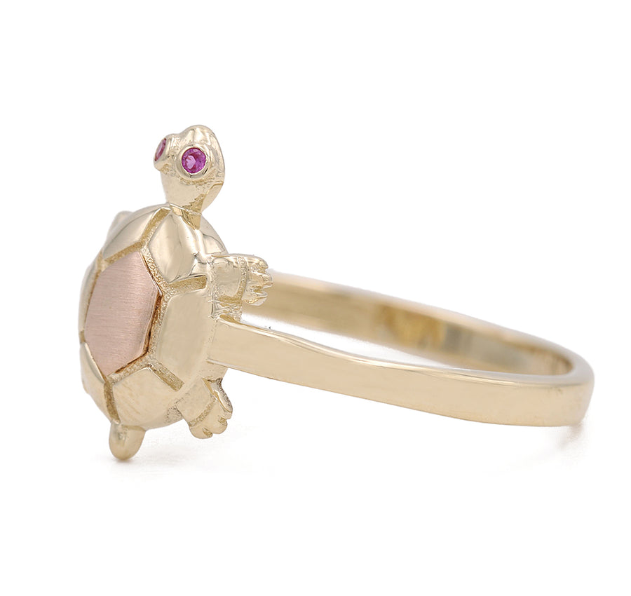 A Miral Jewelry 14K Yellow and Rose Gold Fashion Turtle Ring adorned with pink sapphires.