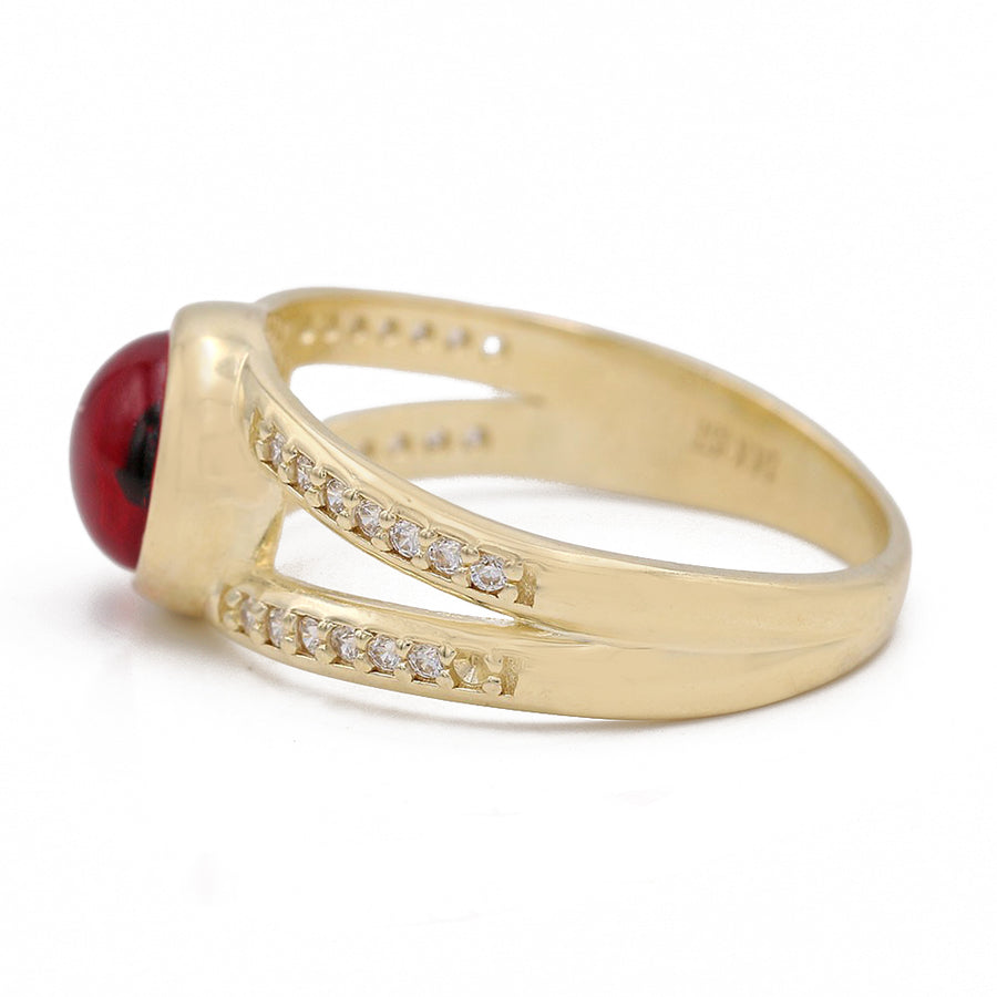 A Miral Jewelry 14K Yellow Gold Fashion Red Evil Eye Ring with Cubic Zirconia and diamonds.