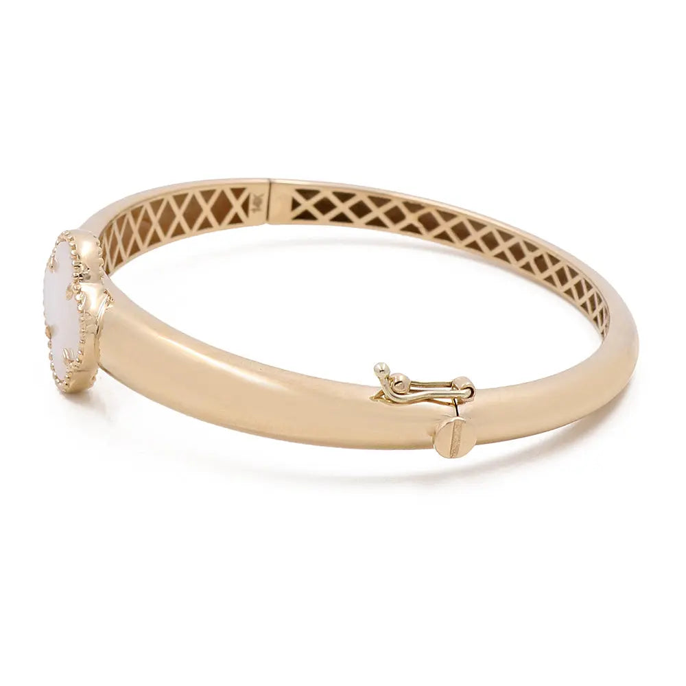 A Miral Jewelry 14K Yellow Gold Fashion Flower Women's Mother of Pearl Bracelet adorned with a round, white mother of pearl centerpiece and an intricate clasp mechanism.