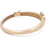 Gold bangle with a clasp and lattice inner design, featuring a small decorative element near the clasp. This Miral Jewelry 14K Yellow Gold Fashion Flower Women's Mother of Pearl Bracelet showcases an exquisite fashion flower design that adds a touch of elegance to any outfit.
