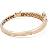 Gold bangle with a clasp and lattice inner design, featuring a small decorative element near the clasp. This Miral Jewelry 14K Yellow Gold Fashion Flower Women's Mother of Pearl Bracelet showcases an exquisite fashion flower design that adds a touch of elegance to any outfit.