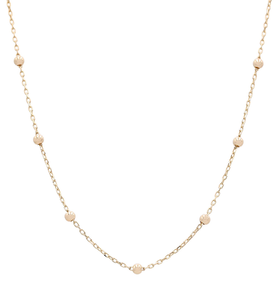 A Miral Jewelry 14k Yellow Gold Beads Chain necklace, consisting of a few gold balls, also known as beads, creating a delicate and stylish piece of jewelry.