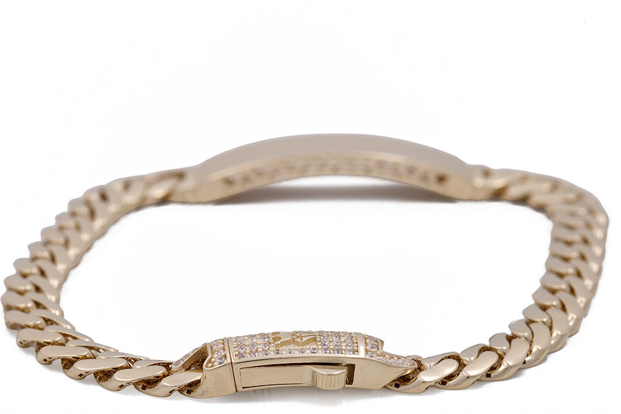 A Miral Jewelry 14K yellow gold Cuban Link Bracelet with Cubic Zirconias.