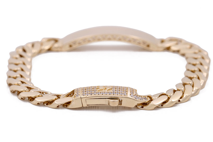 A stunning Miral Jewelry 14K Yellow Gold Cuban Link Bracelet featuring a 14K Yellow Gold design with a shimmering diamond clasp.
