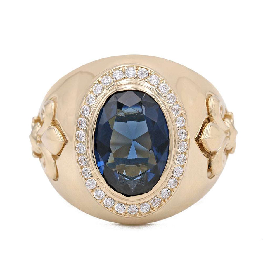 A 14K Yellow Gold Blue Color Center Stone Ring with Cubic Zirconias from Miral Jewelry, featuring a blue sapphire and diamonds.