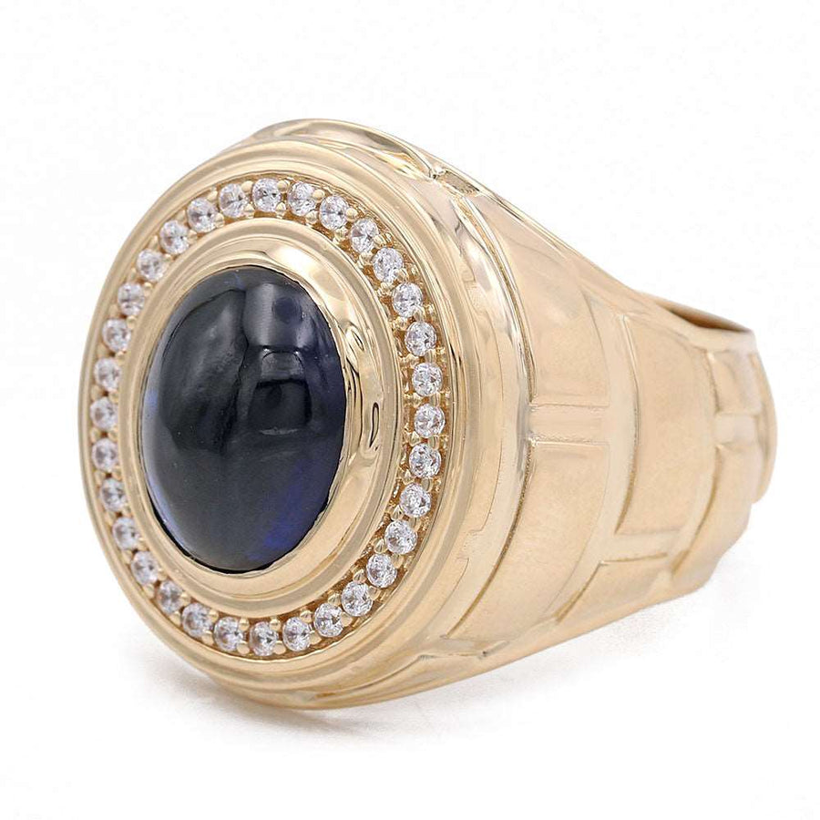 A Miral Jewelry 14K Yellow Gold Black Color Center Stone Ring adorned with a vibrant blue sapphire and sparkling diamonds.