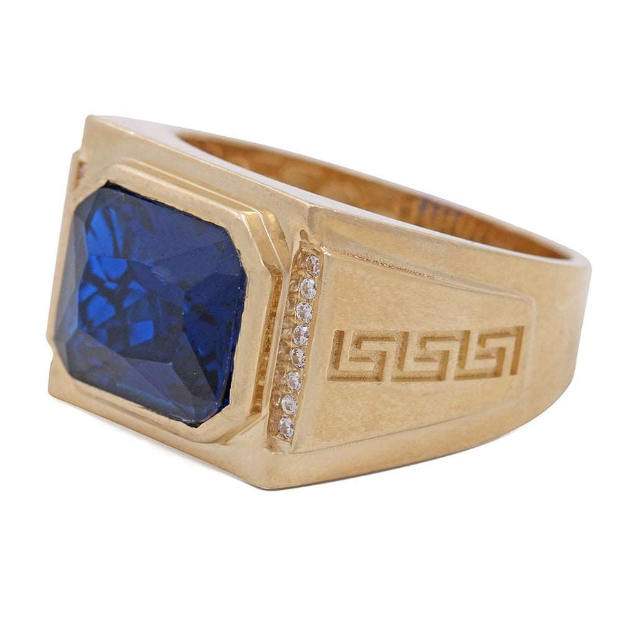 A Miral Jewelry men's fashion ring crafted with 14K yellow gold, featuring a dazzling blue sapphire and shimmering diamonds.