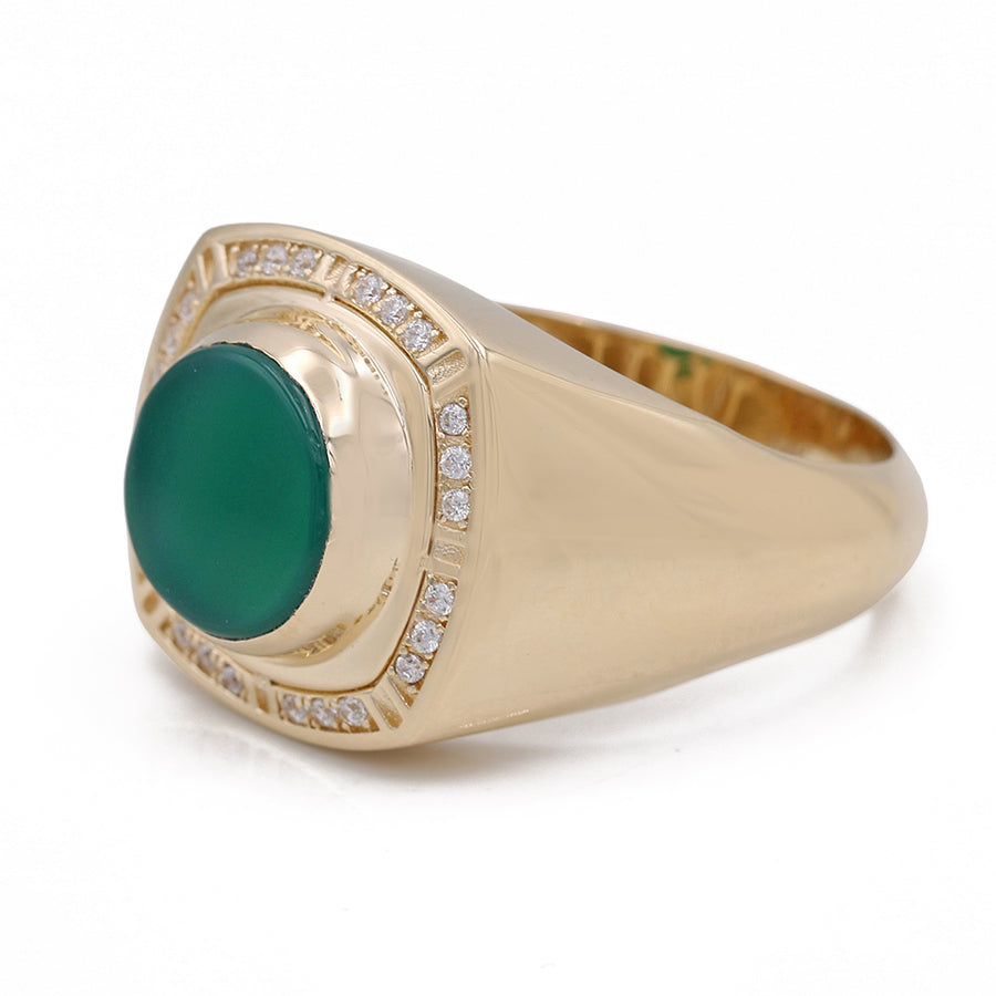 A Miral Jewelry fashion ring featuring a vibrant emerald stone set in exquisite yellow gold, accentuated by shimmering diamonds.