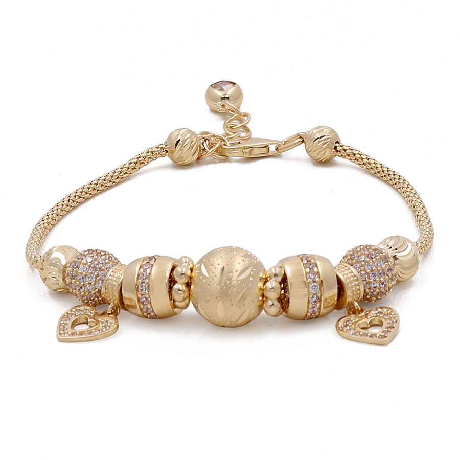 Miral Jewelry's 14K Yellow Gold Women's Fashion Beads with Cubic Zirconias Bracelet featuring heart pendants on a white background.
