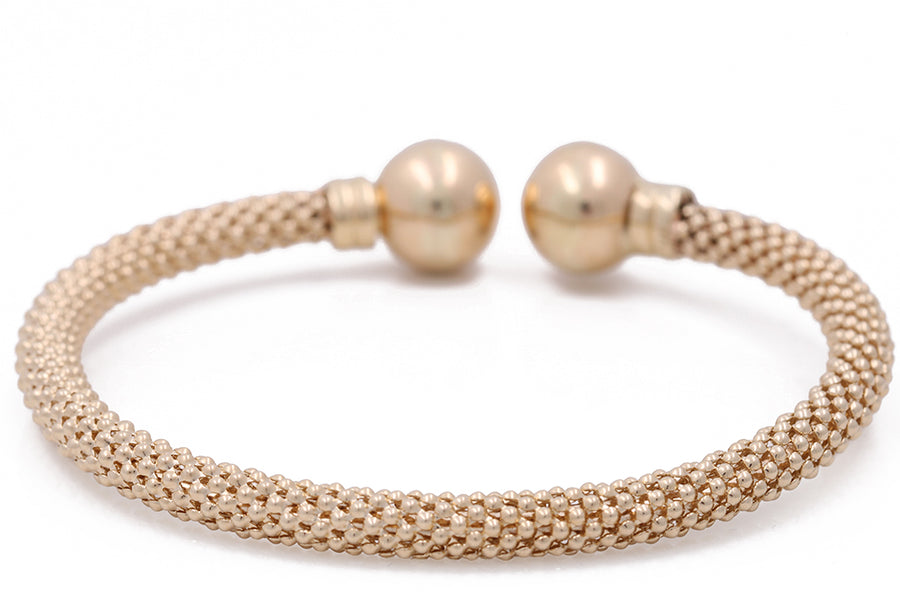 A timeless Miral Jewelry 14K Yellow Gold Fashion Cuff Bracelet with a gold-plated bead.