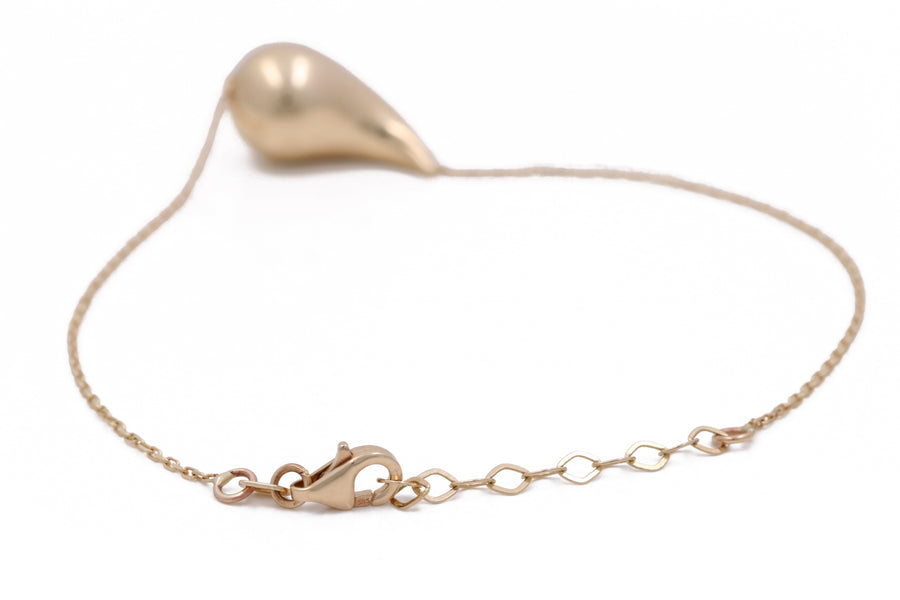 A Miral Jewelry 14K Yellow Gold Women's Fashion Drop Bracelet with a heart shaped charm, perfect for women's fashion.