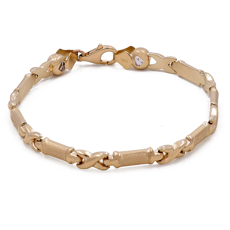 Miral Jewelry's 14K Yellow Gold Women's Fashion Hugs Link Bracelet with lobster clasp and small decorative charms.