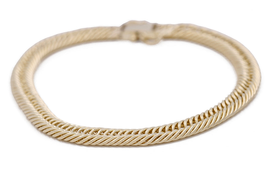 A Miral Jewelry 14K Yellow Gold Braided Fashion Bracelet adorned with a stunning braided design.