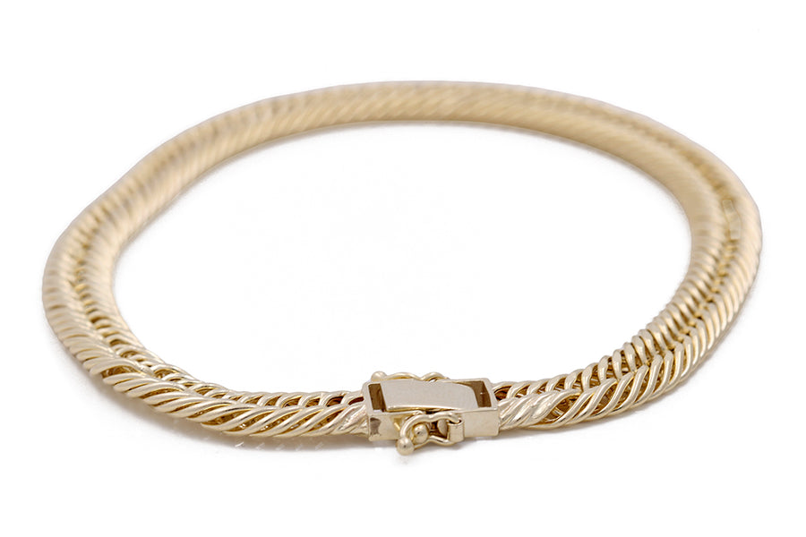 A Miral Jewelry 14K Yellow Gold Braided Fashion Bracelet with a clasp, perfect for any jewelry collection.