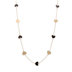 A Miral Jewelry 14K Yellow Gold Fashion Hearts Onyx and Gold Necklace with alternating black onyx-accented and gold heart-shaped charms evenly spaced along the chain.