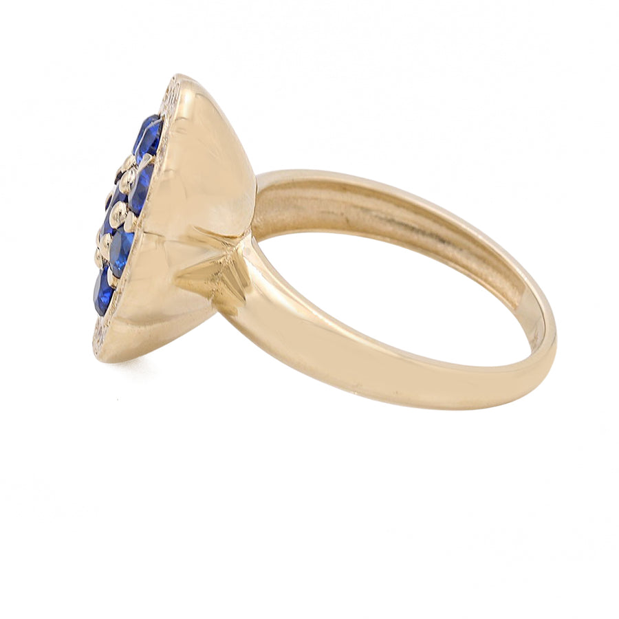 A 14K yellow gold Miral Jewelry ring with a blue sapphire stone.