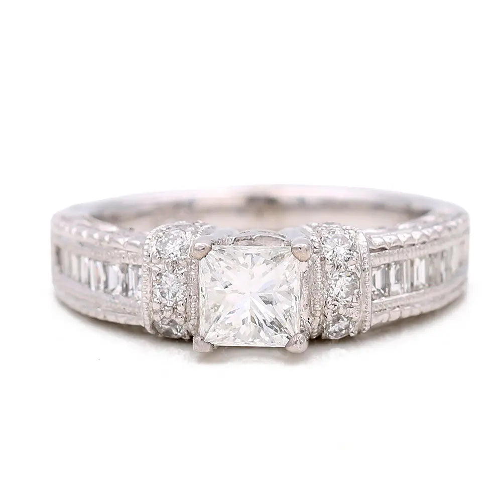 The Miral Jewelry White Gold 10k ring is a stunning women's piece that features a square-cut center diamond, elegantly accented by smaller diamonds set along the band.