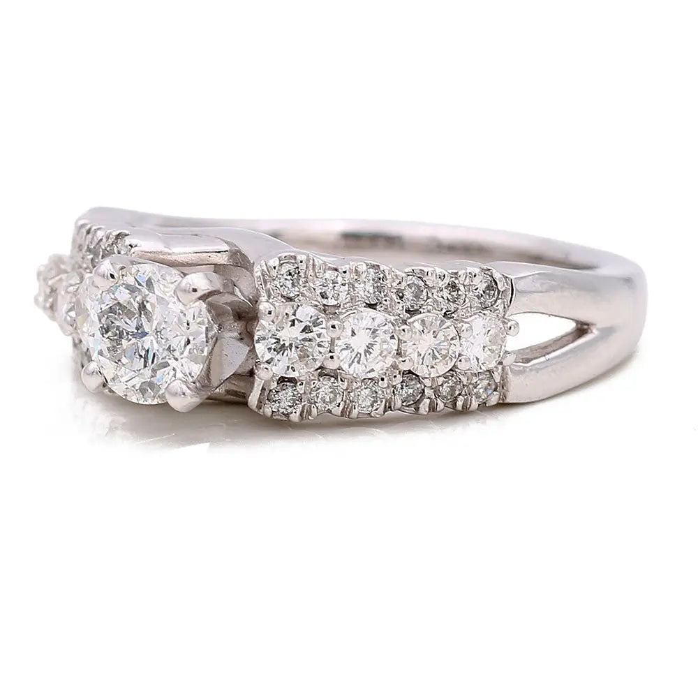 The Miral Jewelry Cocktail Ring in 14K White Gold is designed for women and features a central diamond accented by smaller diamonds on a split shank band.