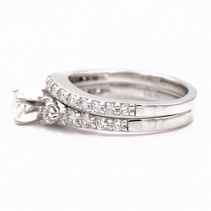A women's Miral Jewelry White Gold 14k Bridal Set Rings with Diamonds engagement ring adorned with diamonds.