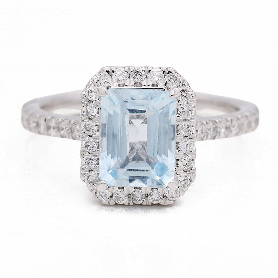 An Miral Jewelry aquamarine and diamond halo ring, crafted in white gold.