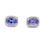 A pair of **Miral Jewelry White 14 Karat Stud Earrings With 0.15Tw Round Diamonds And 2=3.06Tw Oval Tanzanites** featuring oval tanzanites surrounded by small clear stones, all set in 14 karat silver.