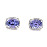 A pair of **Miral Jewelry White 14 Karat Stud Earrings With 0.15Tw Round Diamonds And 2=3.06Tw Oval Tanzanites** featuring oval tanzanites surrounded by small clear stones, all set in 14 karat silver.