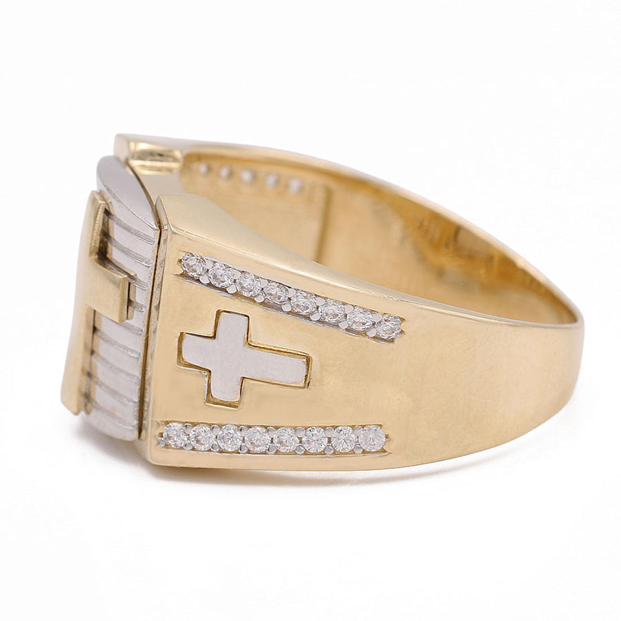 A Miral Jewelry 14K yellow and white gold men's fashion cross ring adorned with diamonds.