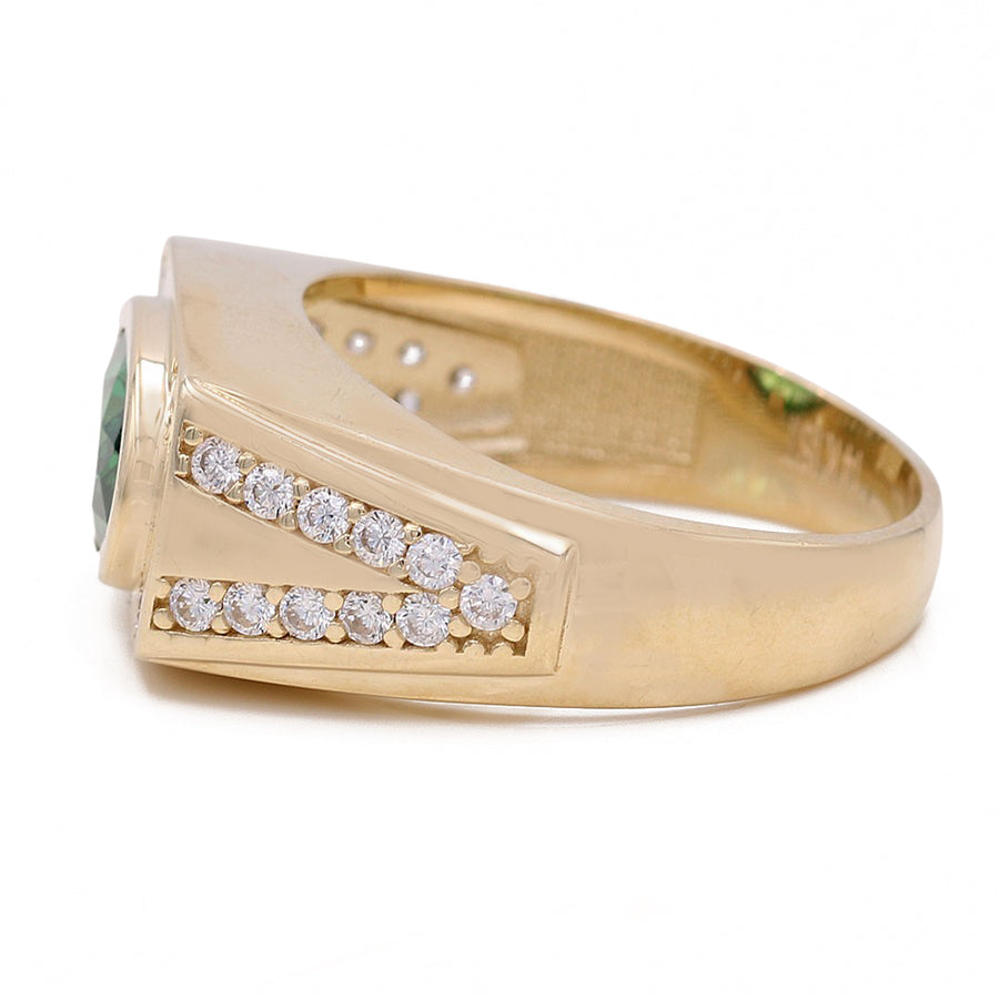 A Miral Jewelry yellow gold 14k fashion ring with a green CZ stone encircled by diamonds.