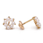 The Miral Jewelry Yellow Gold 14k Pearl Flower Earrings feature a pair of earrings with circular settings, each displaying six small pearls arranged in a ring shape. One earring is shown from the front, while the other is depicted from the side.