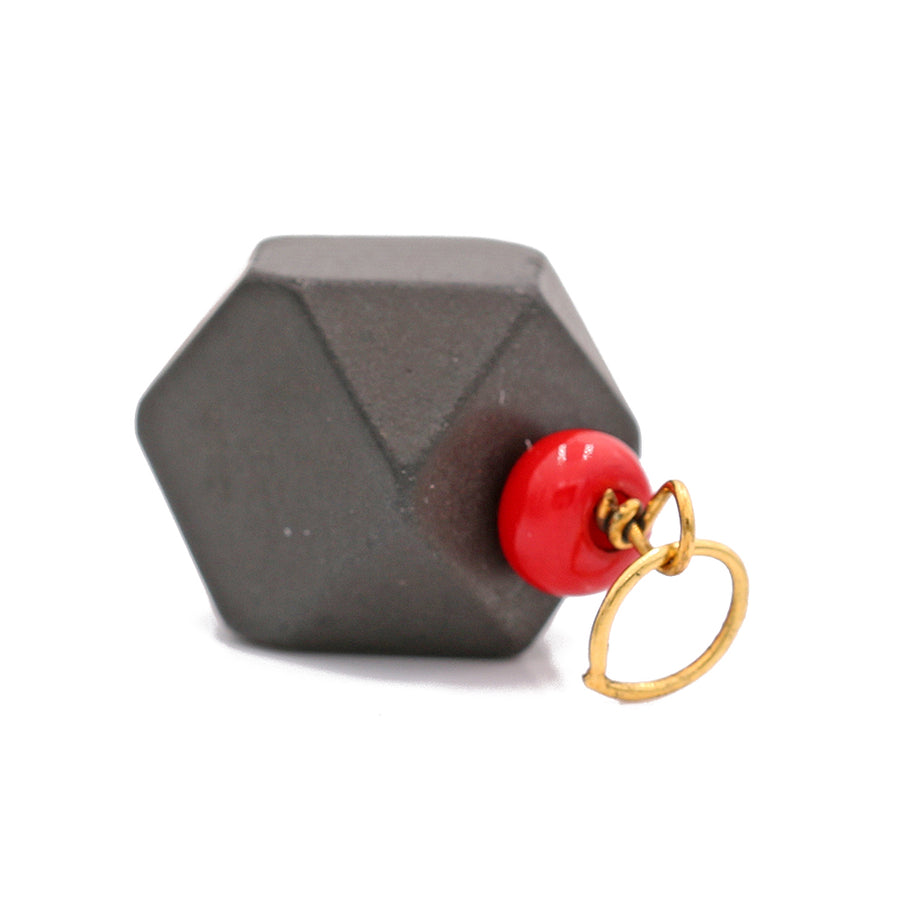 A black and red geometric shape with a red bead, symbolizing protection, crafted in 14k Yellow Gold.
Product Name: Miral Jewelry's 14k Yellow Gold Azabache Pendant.