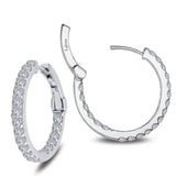 Introducing the Miral Jewelry Hoop Earrings, a stunning pair of sterling silver inside-out hoops adorned with simulated diamonds. One earring is fully closed, showcasing a continuous row of shimmering stones, while the other is half-open, revealing an intricate latch mechanism.