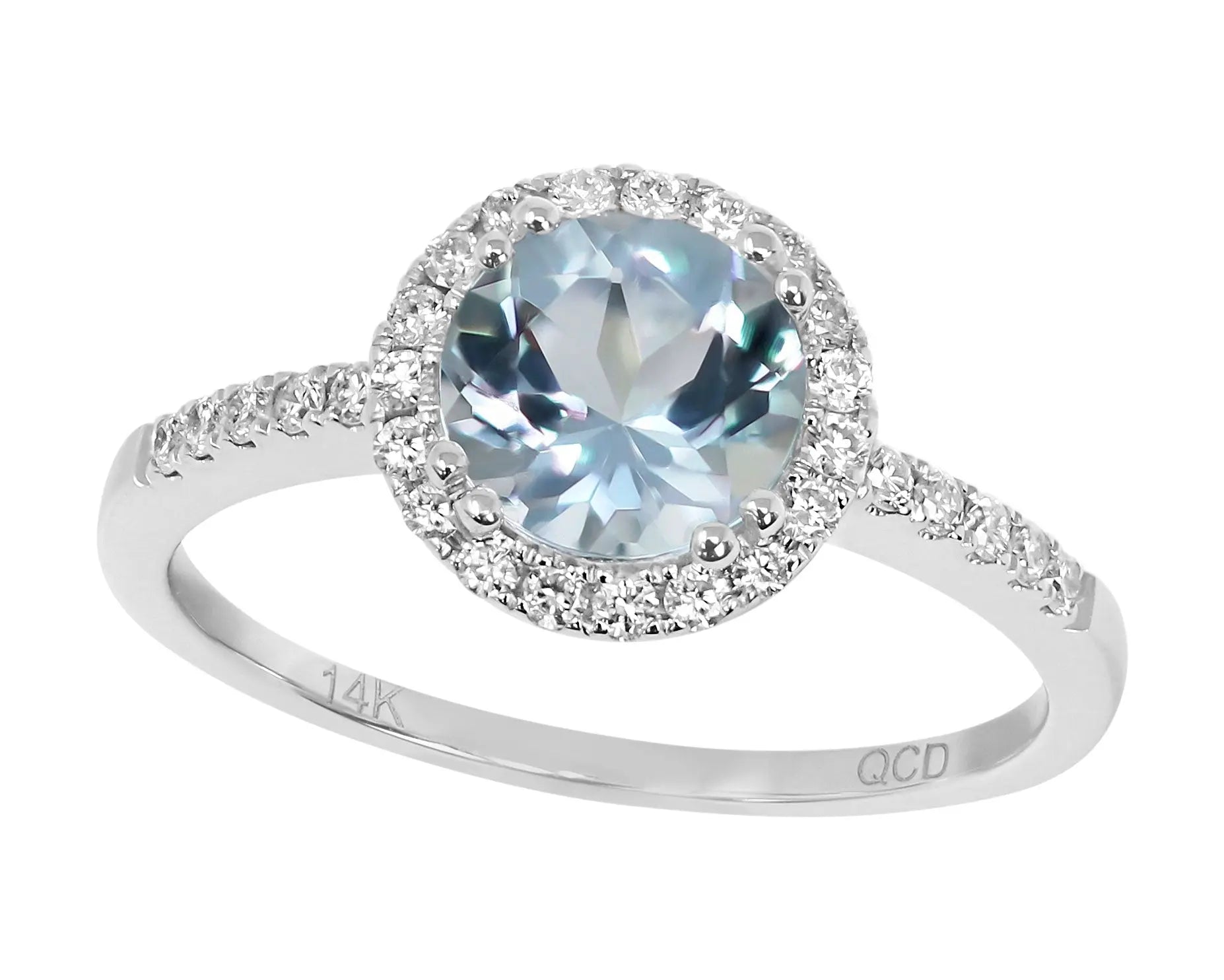 A stunning White 14 Karat Contemporary Fashion Ring With 0.25Tw Round Diamonds And 1.12Tw Round Aqua crafted in 14 karat silver, featuring a large oval gemstone surrounded by smaller round diamonds on the band. It is engraved with "14K" and "QCD." This exquisite piece is part of the Miral Jewelry collection.